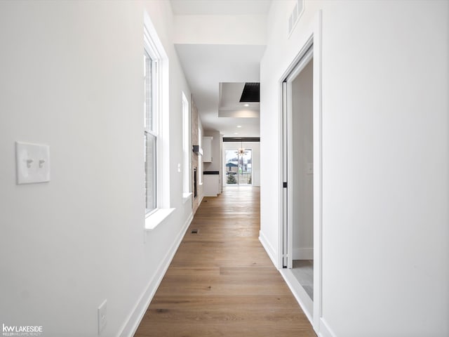 corridor with light wood-type flooring