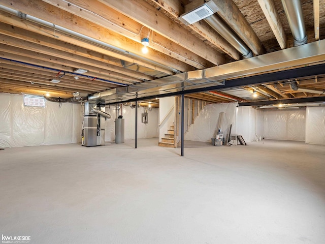 basement with gas water heater and heating unit