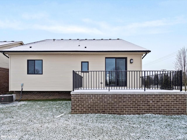 snow covered property featuring cooling unit