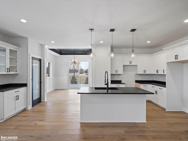 kitchen featuring white cabinets, decorative light fixtures, and sink