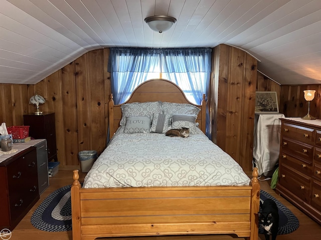 bedroom featuring hardwood / wood-style floors, wood ceiling, lofted ceiling, and wood walls