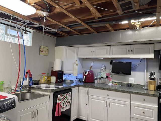 kitchen with white cabinetry, black dishwasher, and washer / clothes dryer