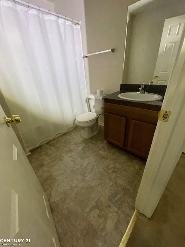 bathroom featuring toilet and vanity