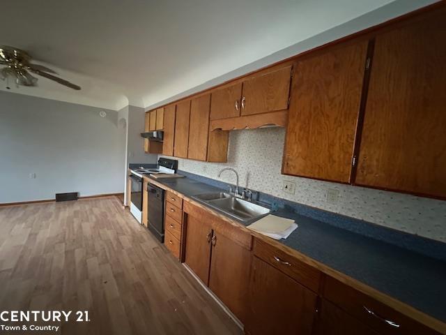 kitchen with ceiling fan, dishwasher, sink, white stove, and light wood-type flooring