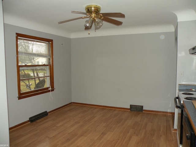 unfurnished room with ceiling fan and light wood-type flooring