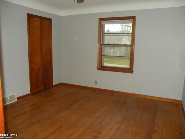 unfurnished room with dark hardwood / wood-style floors