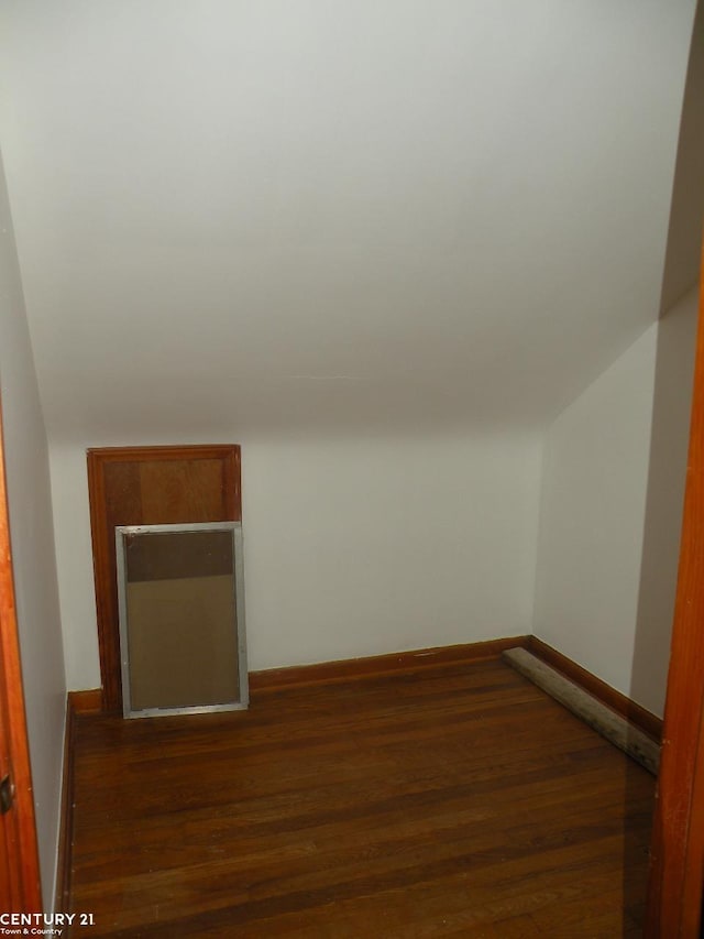 bonus room with dark hardwood / wood-style floors