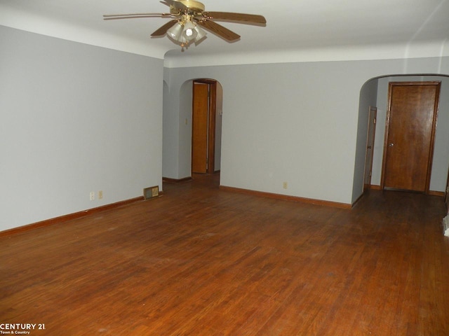 spare room with dark hardwood / wood-style floors and ceiling fan