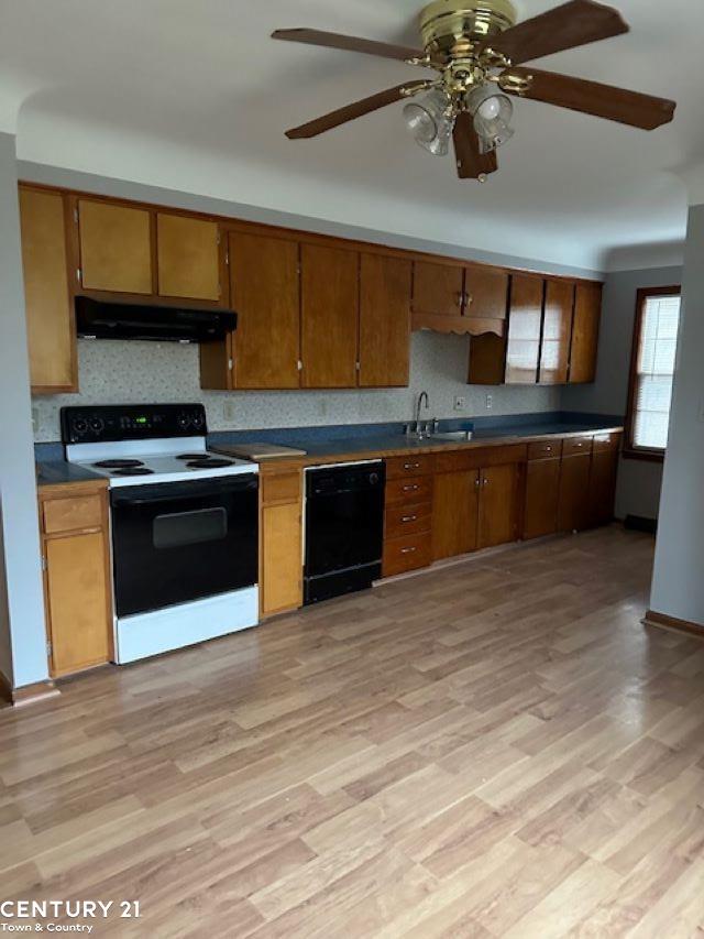 kitchen featuring black dishwasher, light hardwood / wood-style floors, white range with electric stovetop, and sink