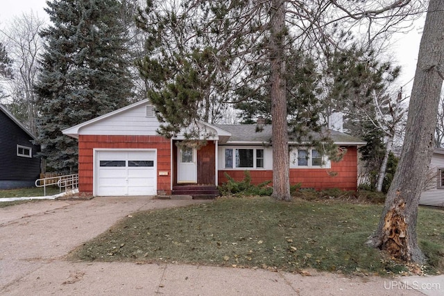 ranch-style home featuring a front lawn and a garage