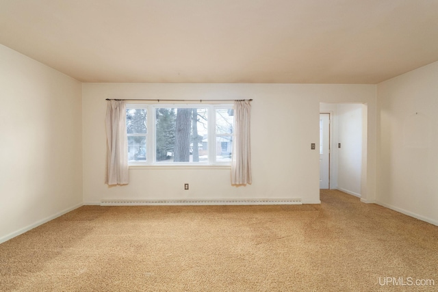 spare room featuring carpet floors and a baseboard radiator