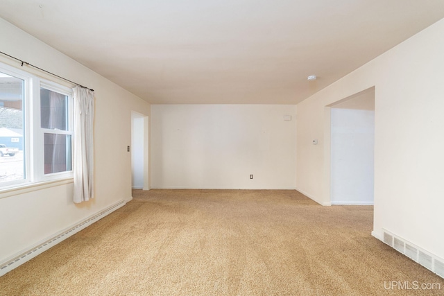 carpeted empty room with baseboard heating