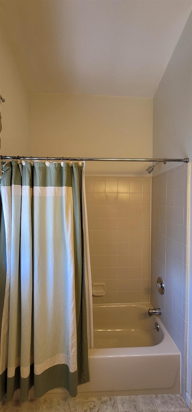 bathroom with tile patterned floors and shower / tub combo with curtain