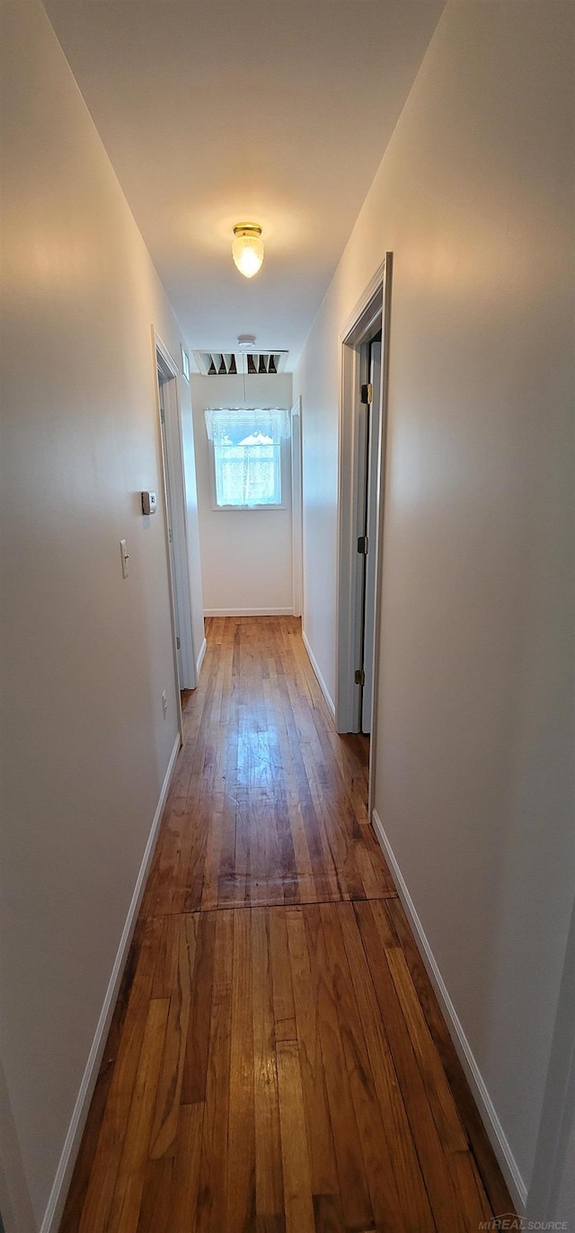 hall with dark hardwood / wood-style flooring