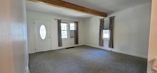 carpeted foyer entrance featuring beamed ceiling