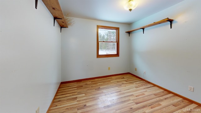 empty room with light hardwood / wood-style flooring