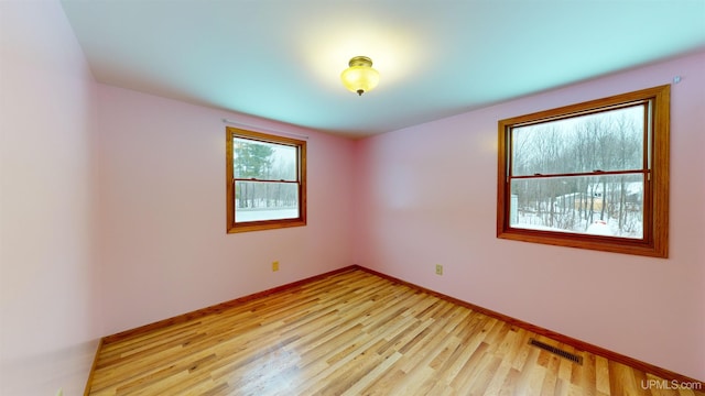 unfurnished room featuring light hardwood / wood-style flooring