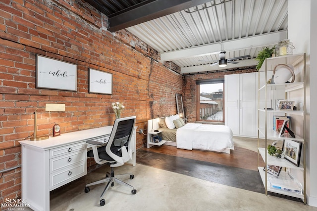 office area with ceiling fan, beamed ceiling, and brick wall