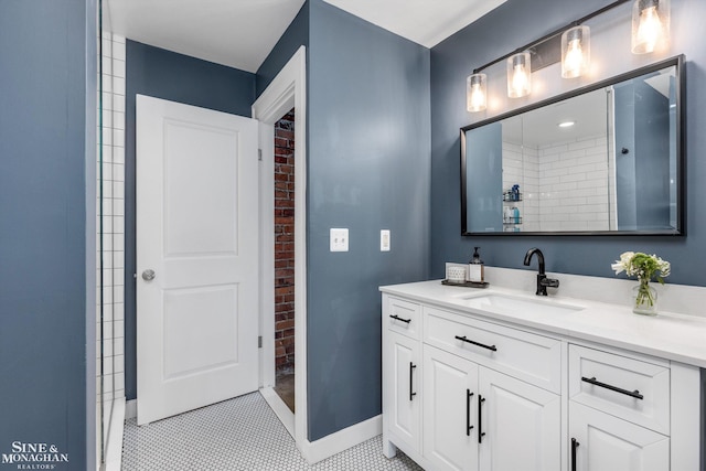 bathroom with a shower, vanity, and tile patterned flooring