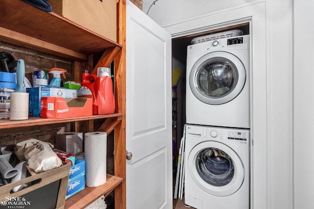 clothes washing area featuring stacked washer and clothes dryer