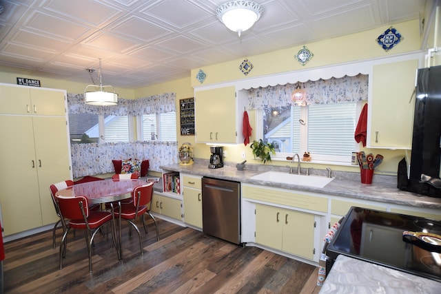 kitchen with pendant lighting, dishwasher, sink, range with electric stovetop, and dark hardwood / wood-style flooring