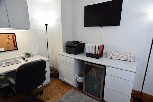 office space with wood-type flooring and wine cooler