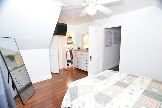 bedroom featuring ceiling fan, a spacious closet, dark hardwood / wood-style floors, a closet, and lofted ceiling