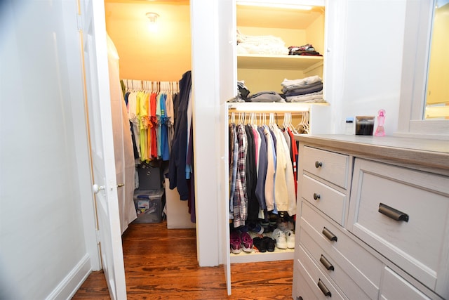 walk in closet featuring dark wood-type flooring