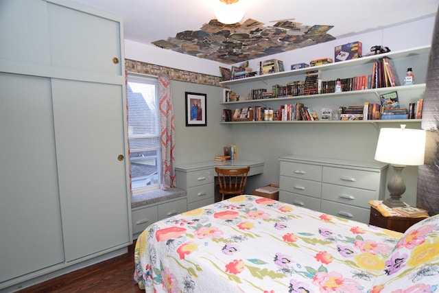 bedroom with dark wood-type flooring and a closet