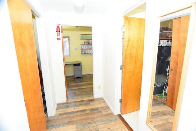 corridor with hardwood / wood-style floors