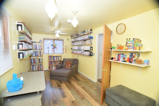 living area with ceiling fan and wood-type flooring