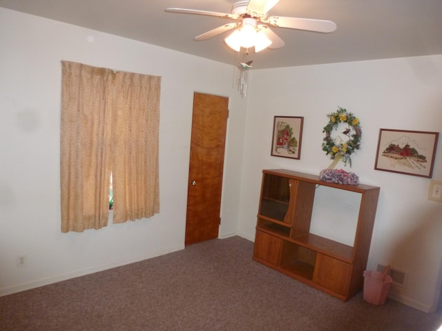 interior space with carpet flooring and ceiling fan