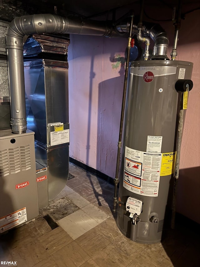 utility room featuring heating unit and water heater