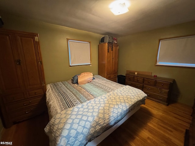 bedroom with dark wood-type flooring