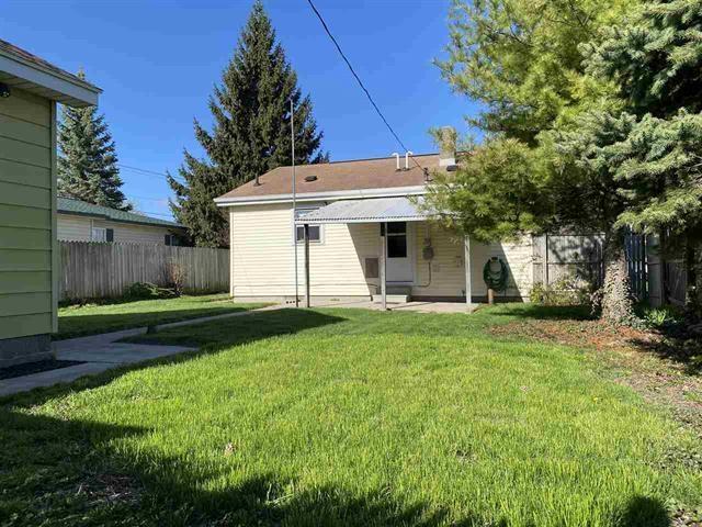 rear view of property with a lawn and a patio area