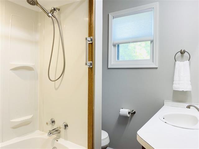 full bathroom featuring vanity, toilet, and washtub / shower combination