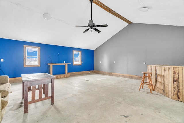 interior space featuring vaulted ceiling with beams, ceiling fan, plenty of natural light, and concrete floors