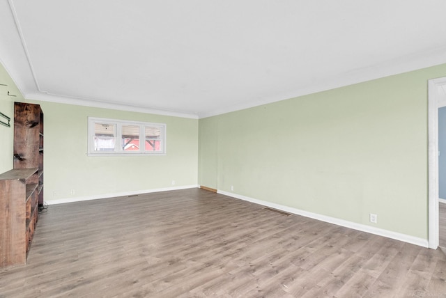 unfurnished room with light hardwood / wood-style flooring and ornamental molding