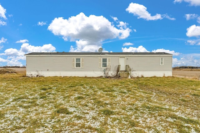 rear view of house with a yard