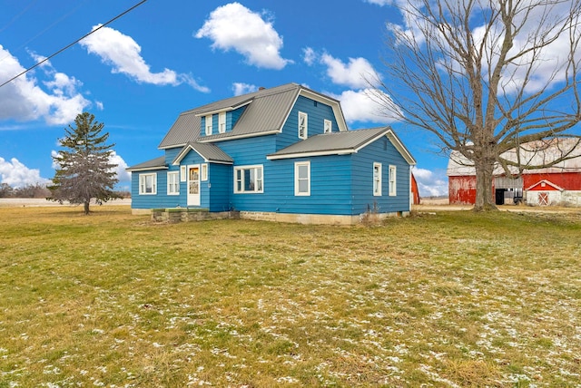 rear view of property featuring a lawn