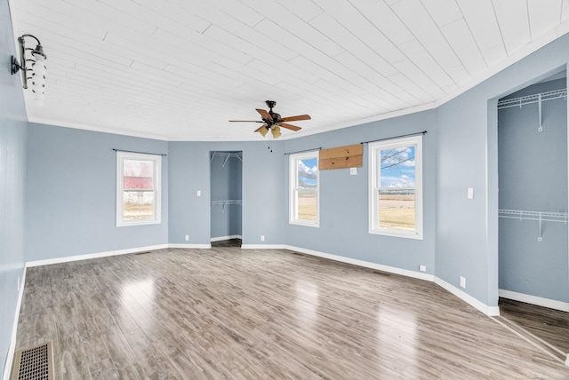 unfurnished bedroom featuring ceiling fan, crown molding, wood ceiling, and wood-type flooring