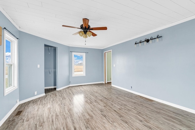 unfurnished room featuring wood-type flooring, ceiling fan, ornamental molding, and wood ceiling