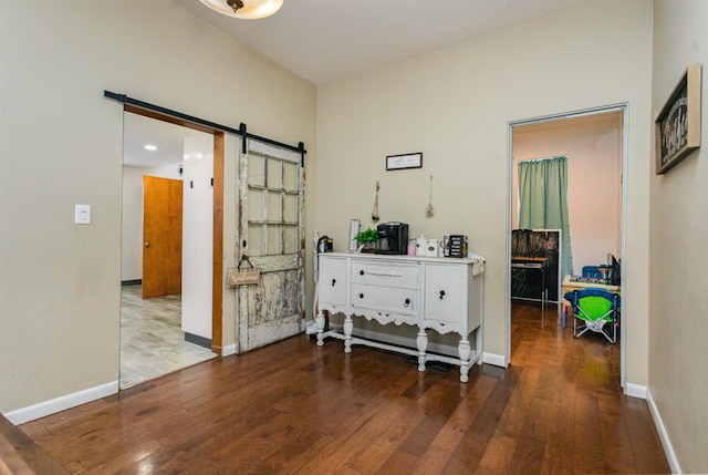 hall featuring a barn door and hardwood / wood-style flooring