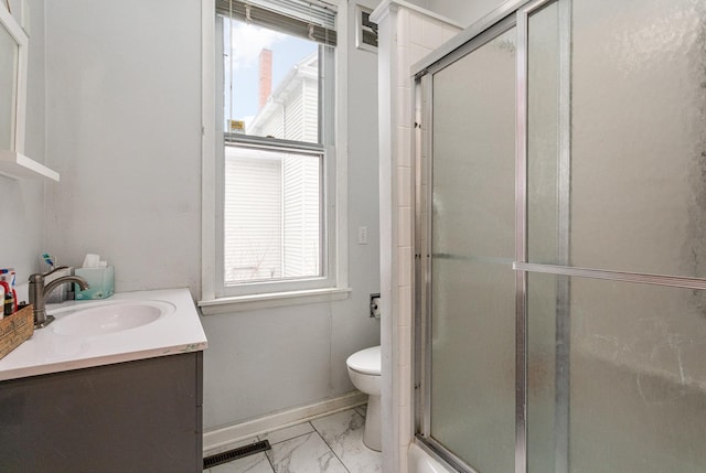 full bathroom with vanity, a healthy amount of sunlight, toilet, and enclosed tub / shower combo