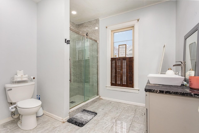 bathroom with a shower with door, vanity, and toilet