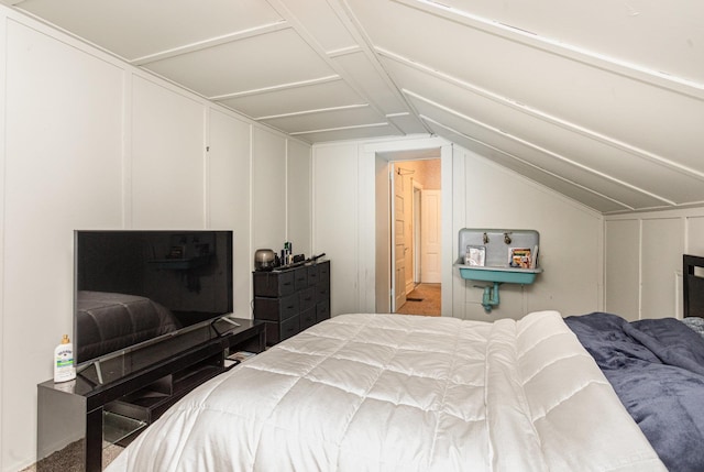 bedroom featuring carpet and lofted ceiling