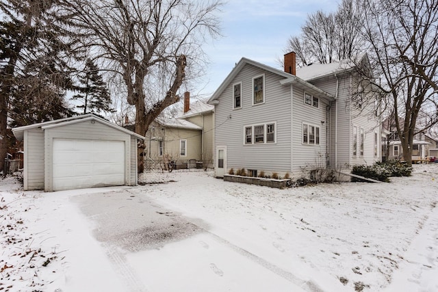 front of property with a garage and an outdoor structure