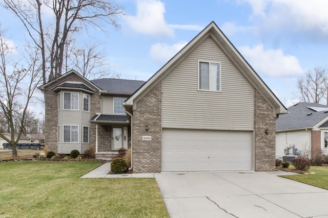 view of property featuring a garage and a front yard