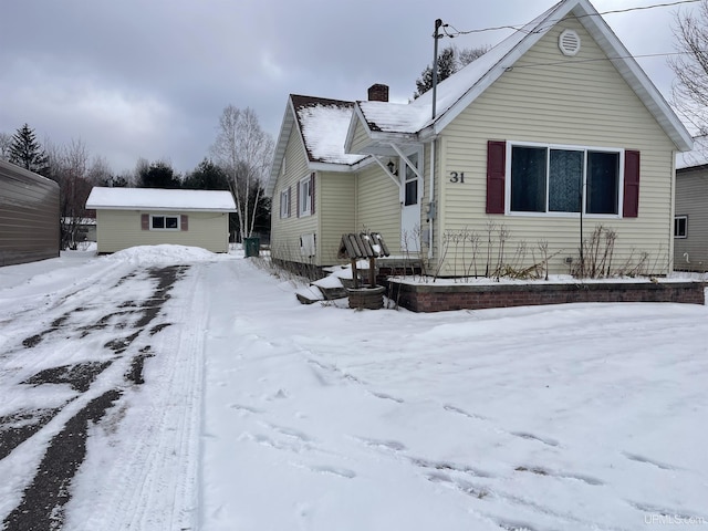 bungalow-style house with an outbuilding