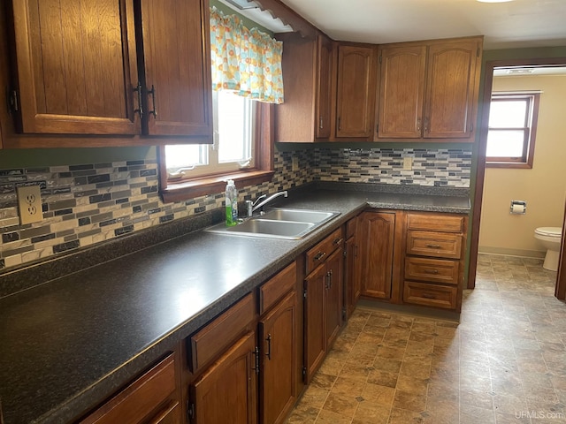 kitchen with plenty of natural light, sink, and tasteful backsplash